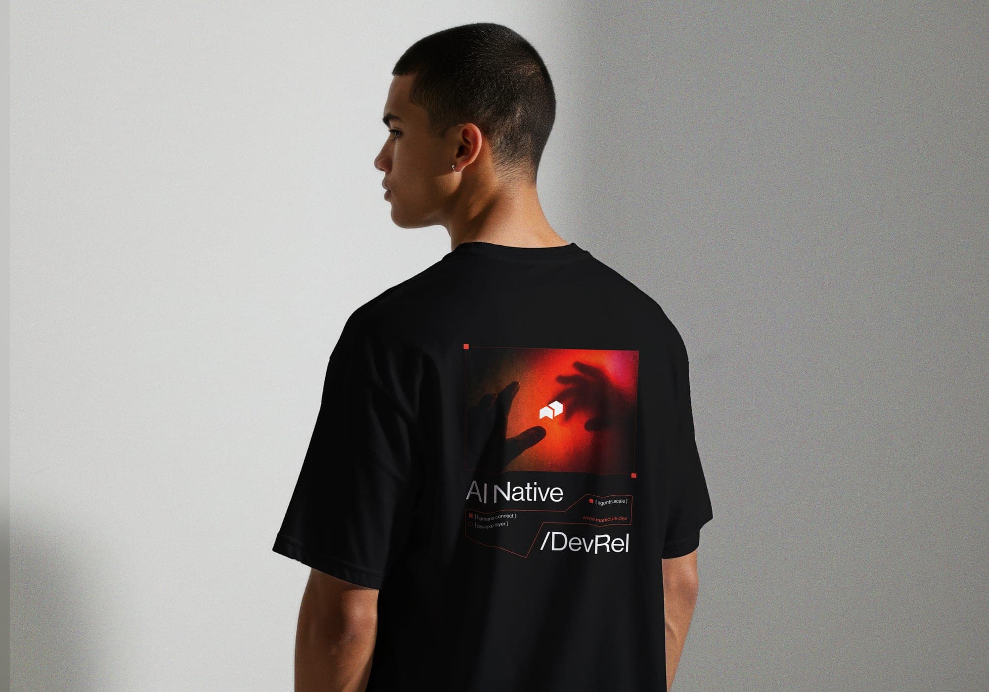 Model wearing the black tee, back print reading AI Native slash DevRel.